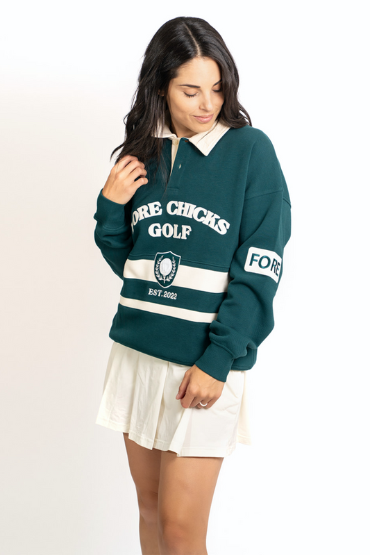 Woman wearing a green and white golf-themed sweater on a white background
